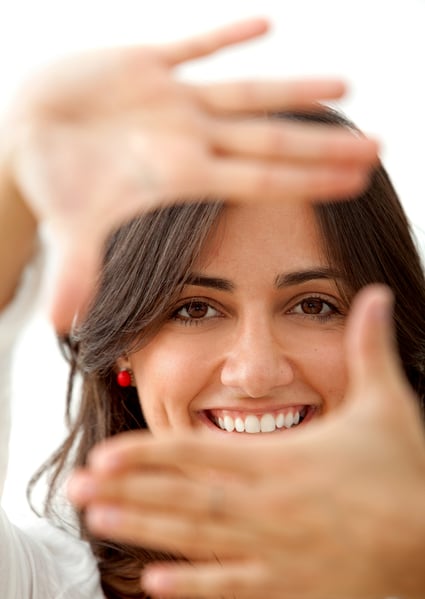 Beautiful woman framing her face isolated over white